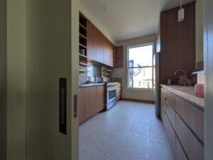 a kitchen with wood cabinets and a window